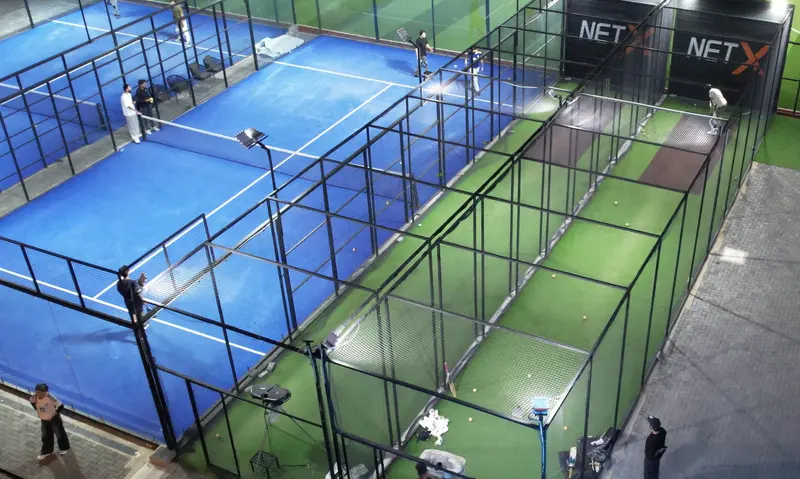 Bowling machine lanes beside the padel courts
