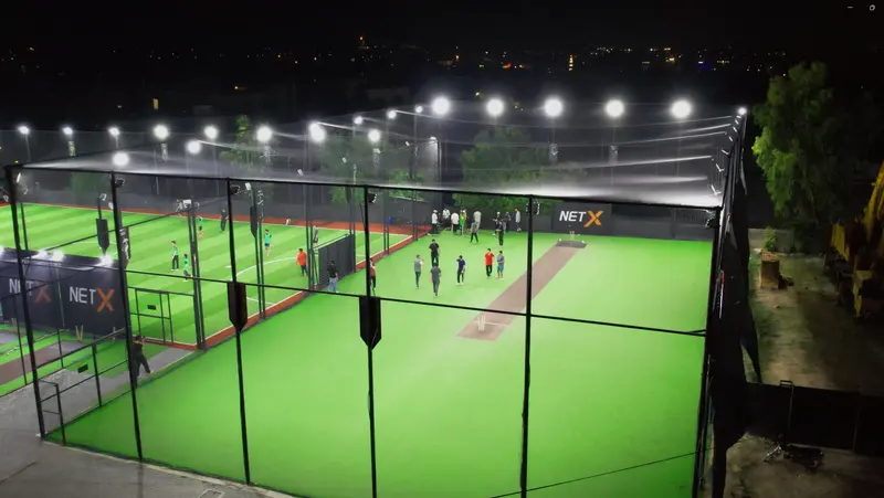 Players in the illuminated NETX Box Cricket